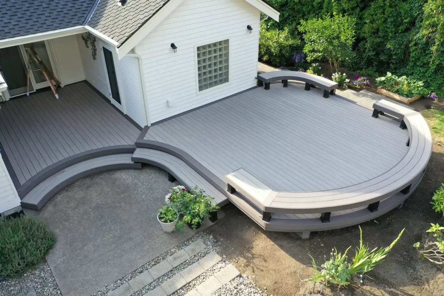 aerial-view-of-the-custom-gray-residential-deck-with-benches-on-the-modern-house-surrounded-by-greenery-and-trees-in-tacoma-wa