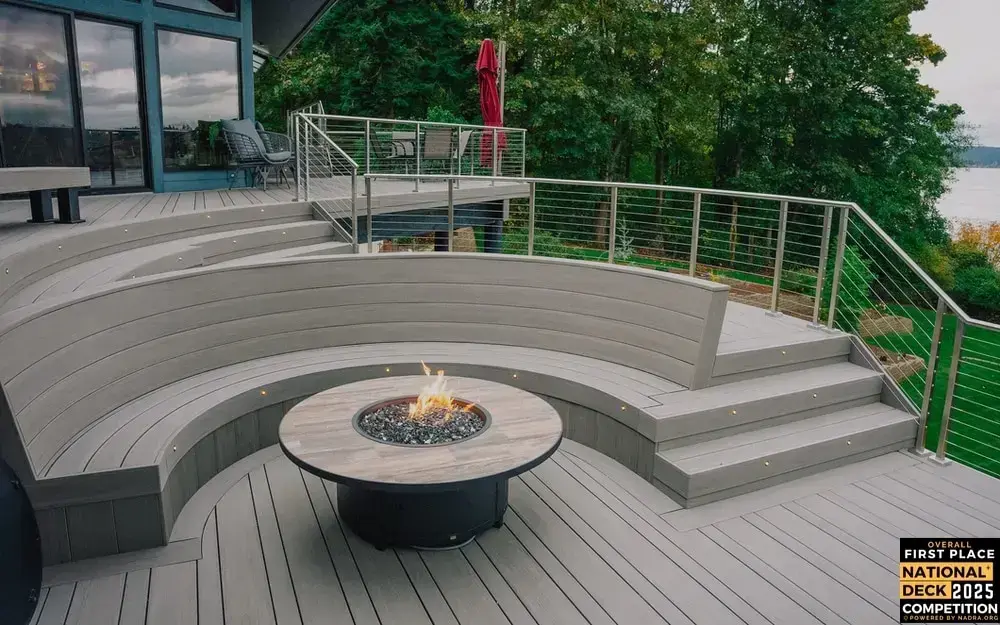 custom-pvc-deck-with-bench-and-fire-pit-with-cable-railing-and-outdoor-living-dining-set-featuring-big-trees-and-lake-view-in-tacoma-wa