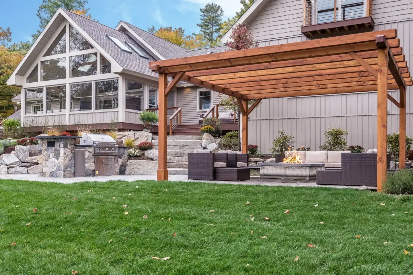 outdoor-living-fire-place-with-fire-pit-under-the-wooden-pergola-featuring-screened-in-porch-on-the-custom-deck-in-tacoma-wa
