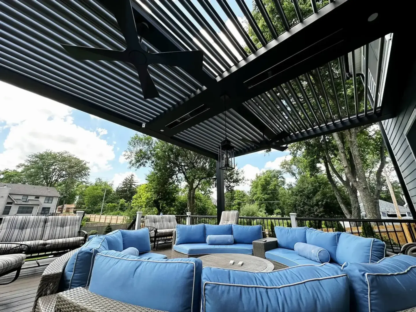 outdoor-sofa-under-louvered-pergola-with-fan-and-light