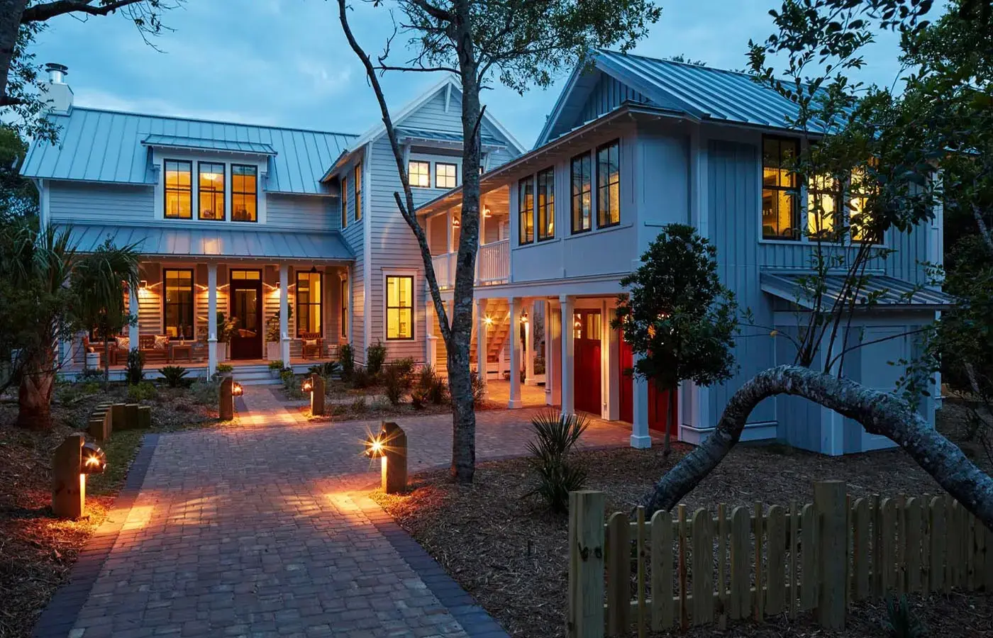 patio-construction-on-the-white-house-with-front-porch-and-outdoor-living-sofa-featuring-wooden-picket-fence-in-tacoma-wa