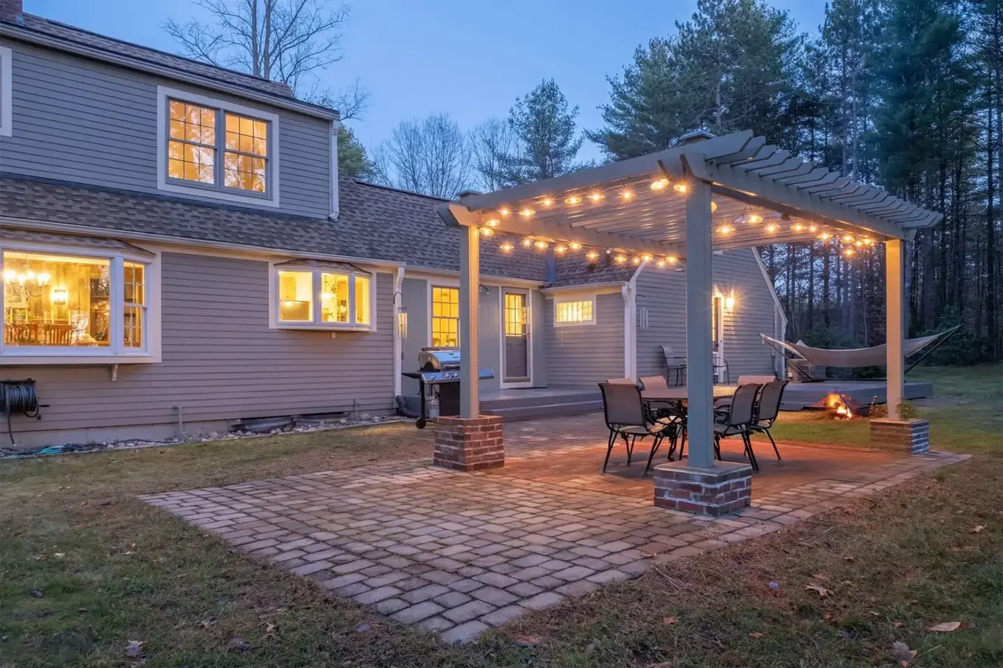 patio-construction-with-white-pergola-with-lighting-on-the-modern-house-with-big-tree-on-the-background-in-tacoma-wa